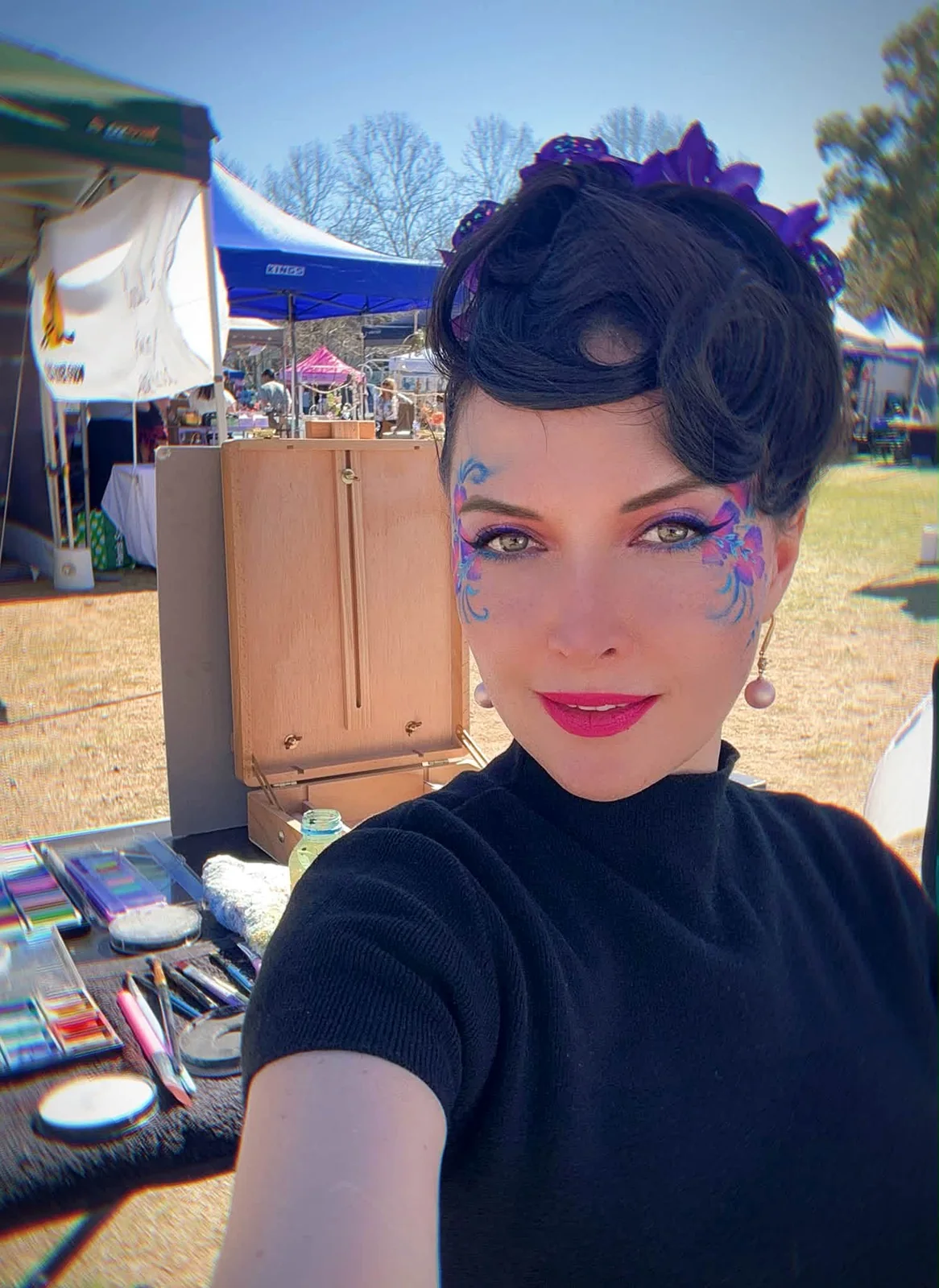 Tori Addams working at a face painting market stall